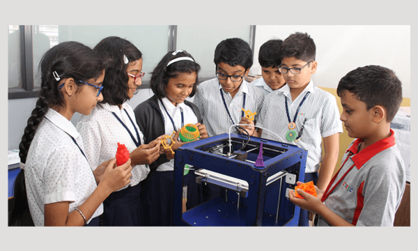 Students eagerly observing a 3D printing demonstration with excitement and curiosity