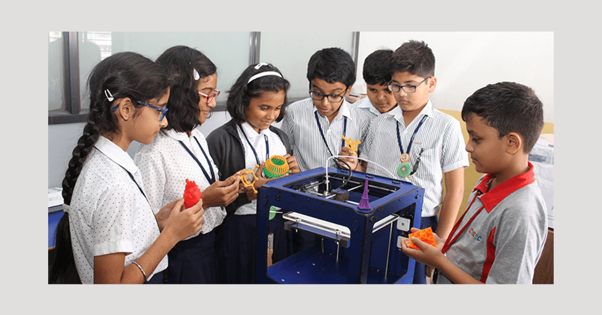 Students eagerly observing a 3D printing demonstration with excitement and curiosity