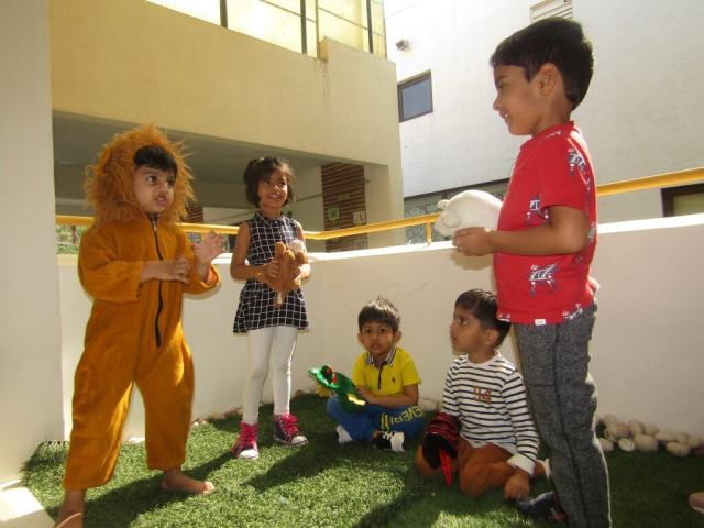 CHIREC pre primary students engaging in an activity, students dressed up a lion while other students are holding other animal characters