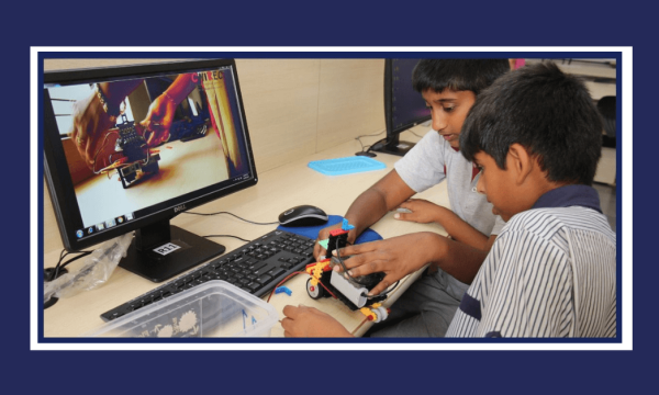 CHIREC students learning to use robotics kit while watching tutorial video