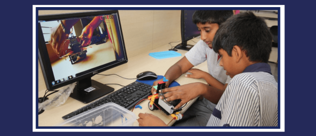 CHIREC students learning to use robotics kit while watching tutorial video