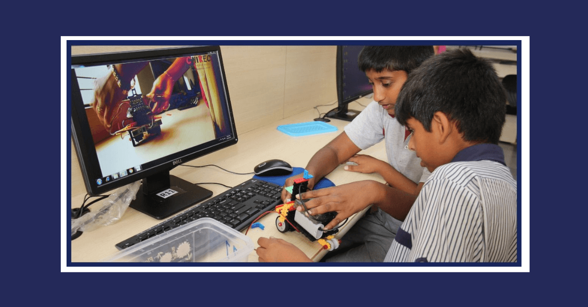 CHIREC students learning to use robotics kit while watching tutorial video
