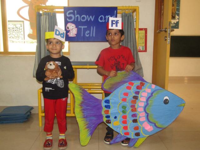 CHIREC pre-primary students holding Doll of a dog and fish art, actively engage in a show-and-tell activity centered around the letter "D and F."